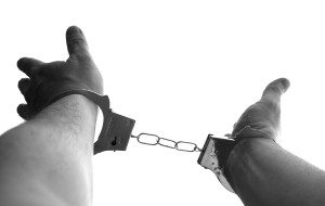 Handcuffed man reaching for bail